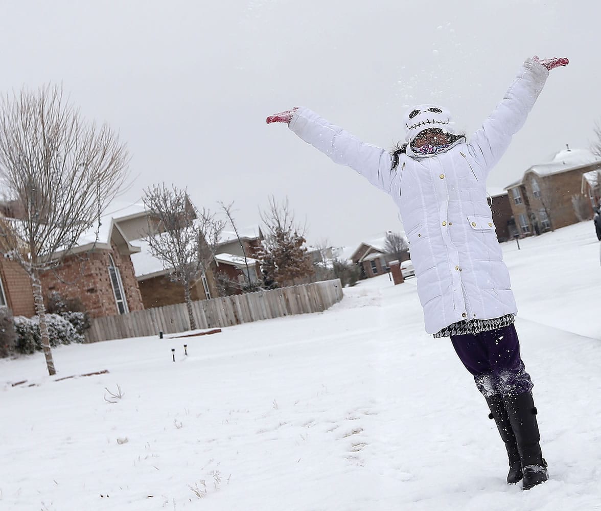 Breanne Valdez plays in the snow in Lubbock, Texas, on Wednesday.