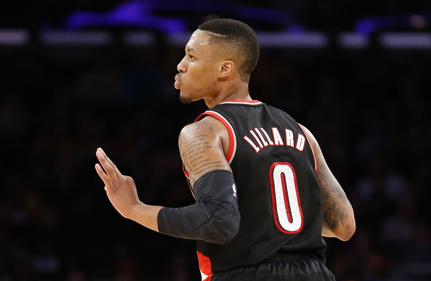 Portland Trail Blazers guard Damian Lillard reacts after making a three-pointer against the Los Angeles Lakers Tuesday in Los Angeles.