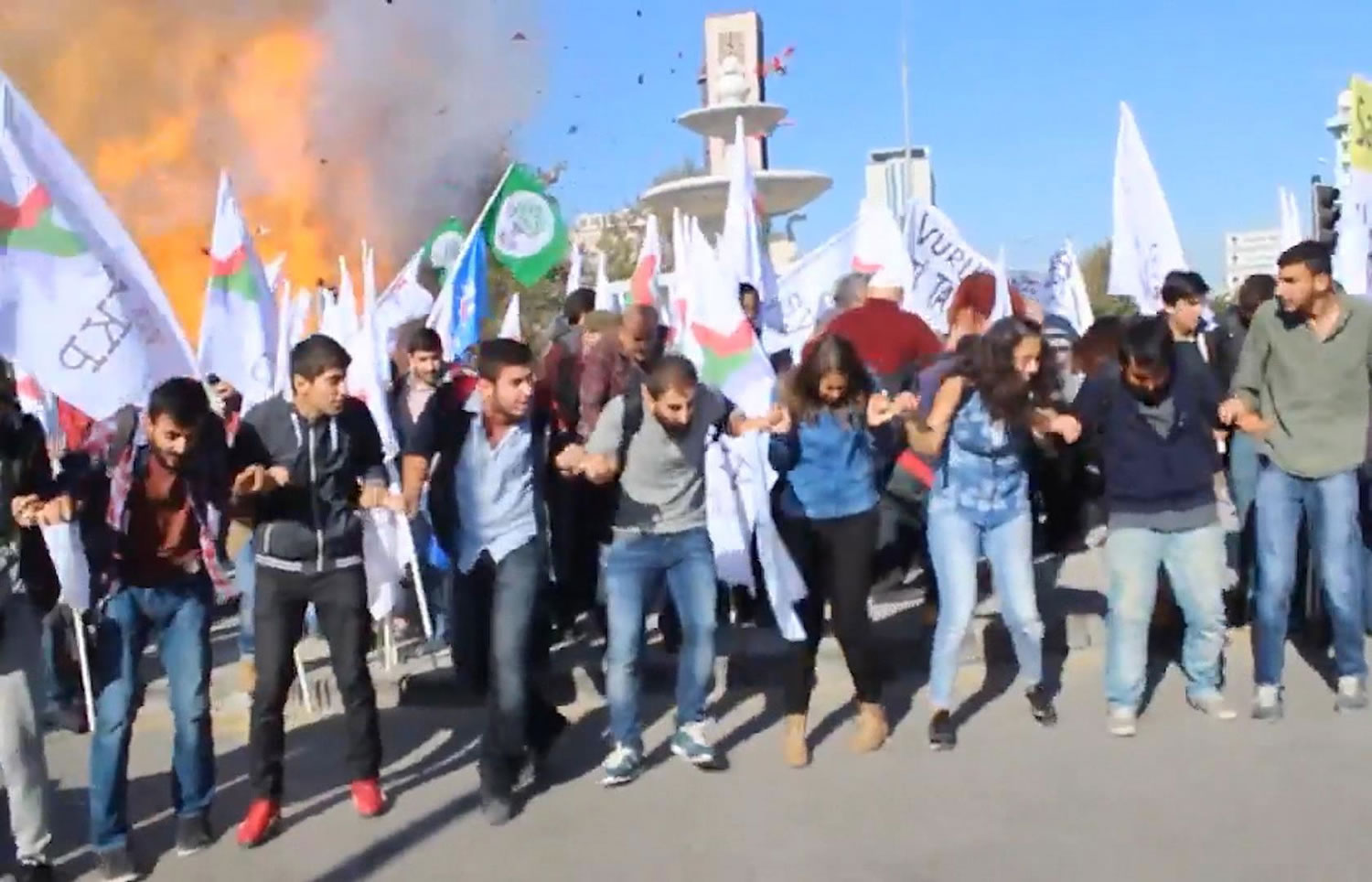 In this image from video, people at a peace rally react as an explosion goes off behind them Saturday in Ankara, Turkey.