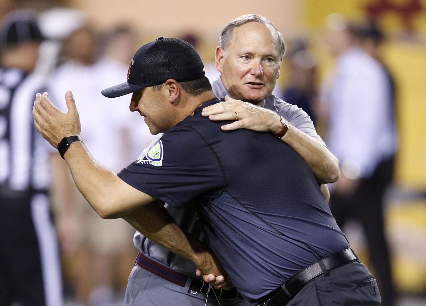 Southern California coach Steve Sarkisian, front, hugs Southern California athletic director Pat Haden prior to the team&#039;s NCAA college football game against Arizona State on Saturday, Sept. 26, 2015, in Tempe, Ariz. (AP Photo/Ross D.