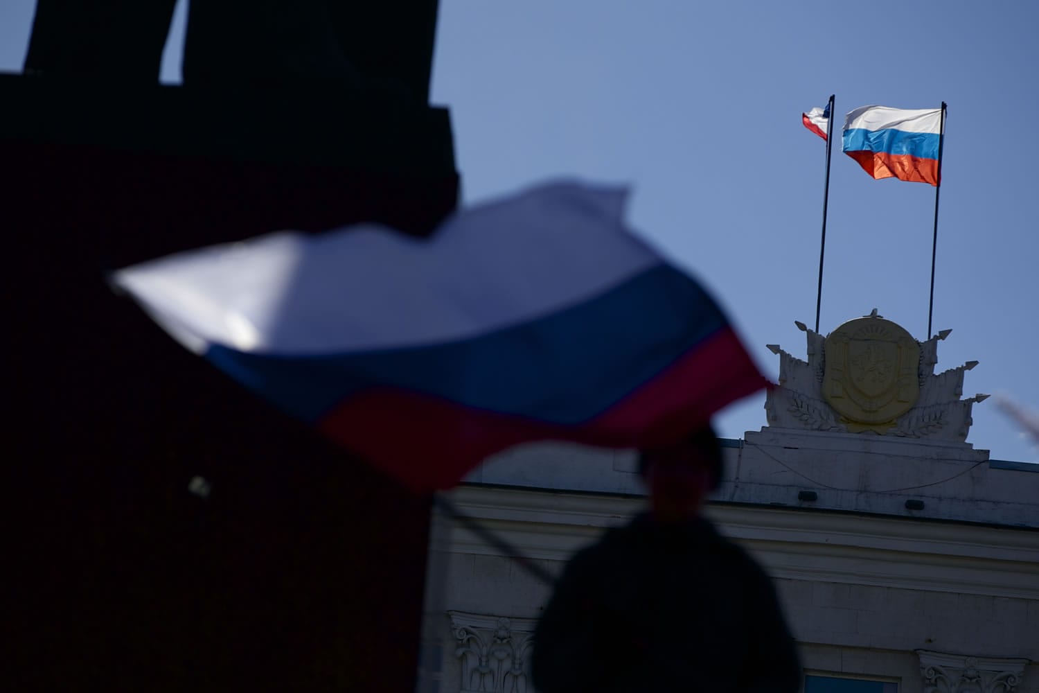 Russian and Crimean flags fly over a local government building in Simferopol, Ukraine, on Monday.