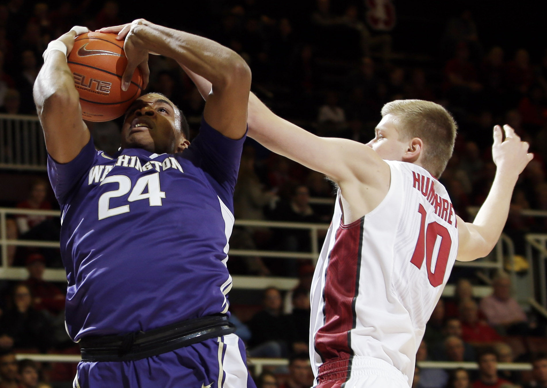 Washington center Robert Upshaw, left, tries to shoot as Stanford forward Michael Humphrey defends during the first half Sunday, Jan. 4, 2015, in Stanford, Calif.