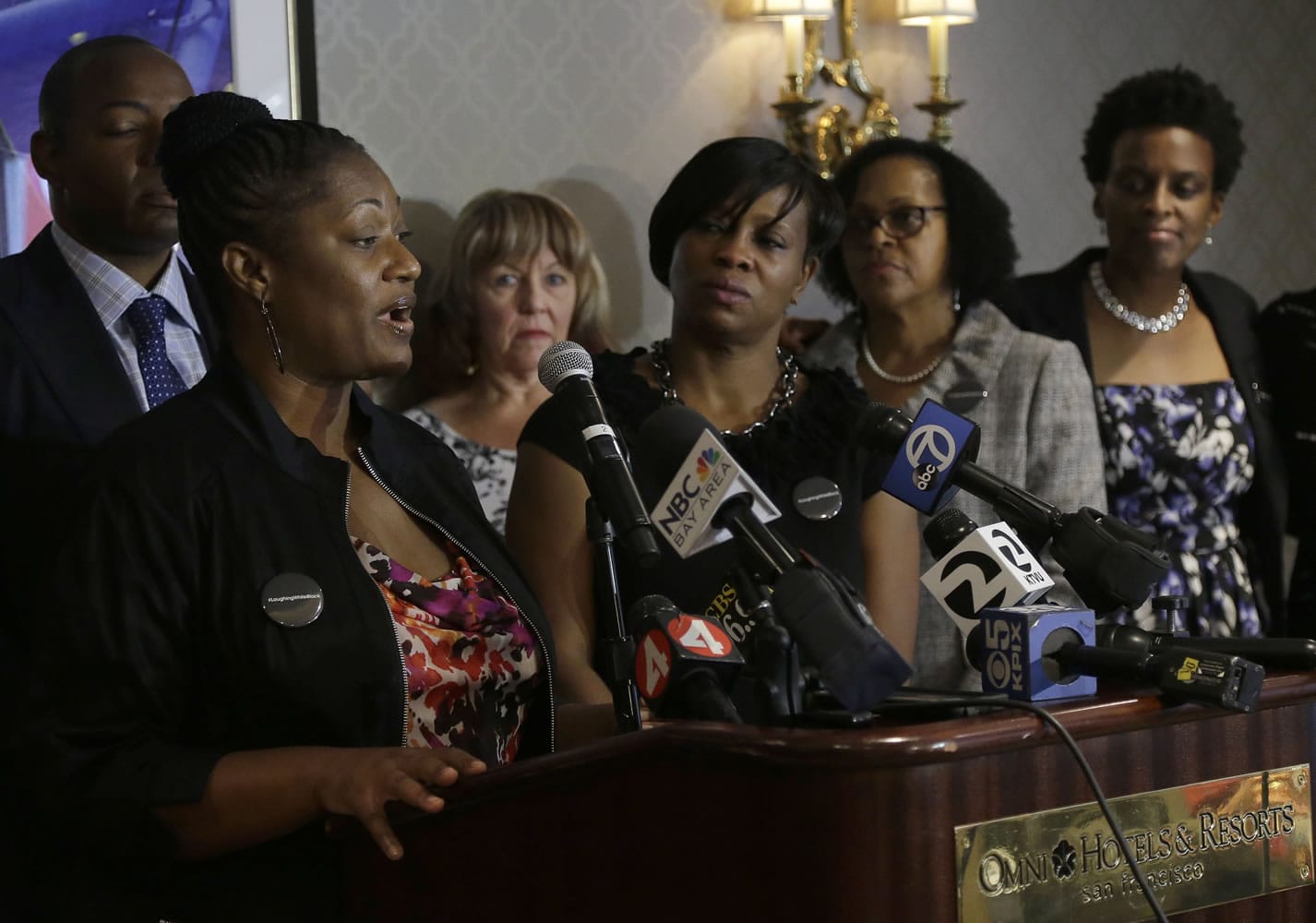 Tira McDonald, left, one of the plaintiffs filing a lawsuit over their ejection from a Napa Valley Wine Train, speaks at a news conference Thursday in San Francisco. Also pictured are attorney Waukeen Q. McCoy, from left rear, and plaintiffs Linda Carlson, Lisa Johnson, Sandra Jamerson and Allisa Carr. A group of mostly black women who were ejected from a Northern California wine country train this summer say they felt humiliated.