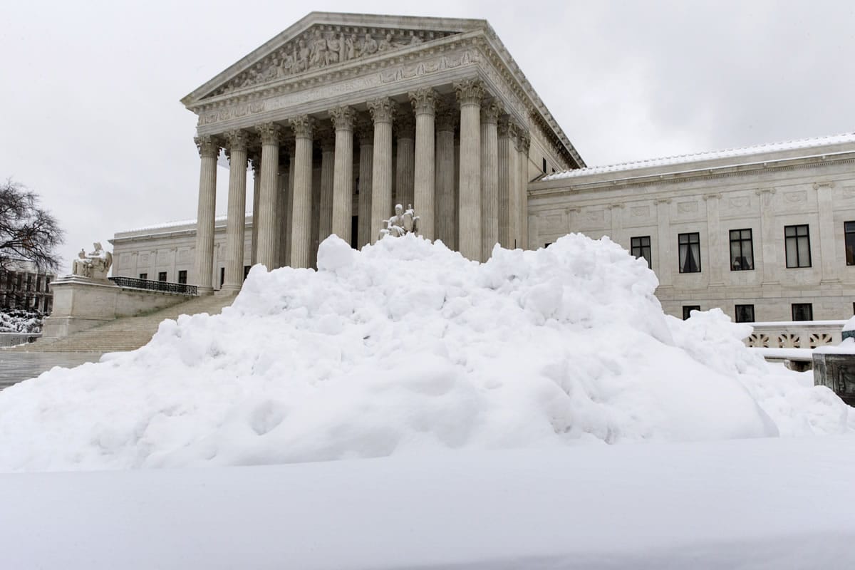 Shoveled snow is piled up at the Supreme Court in Washington on Monday after a St.