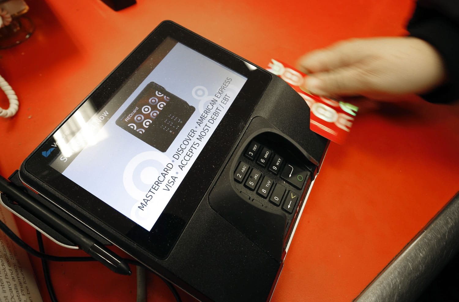 Associated Press files
A shopper pays for purchases at a Target store in South Portland, Maine. Criminals stole personal information from tens of millions of Americans in data breaches in 2014.