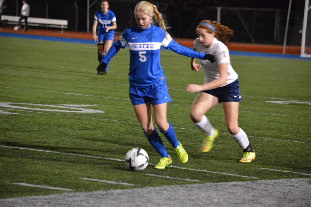 Ridgefield midfielder Kelly Casper dribbles past an Ellensburg defender in the 2A state girls soccer semifinals Friday in Shoreline. The Spudders won 5-1 and will play for their first state title against Squalicum at 4 p.m.