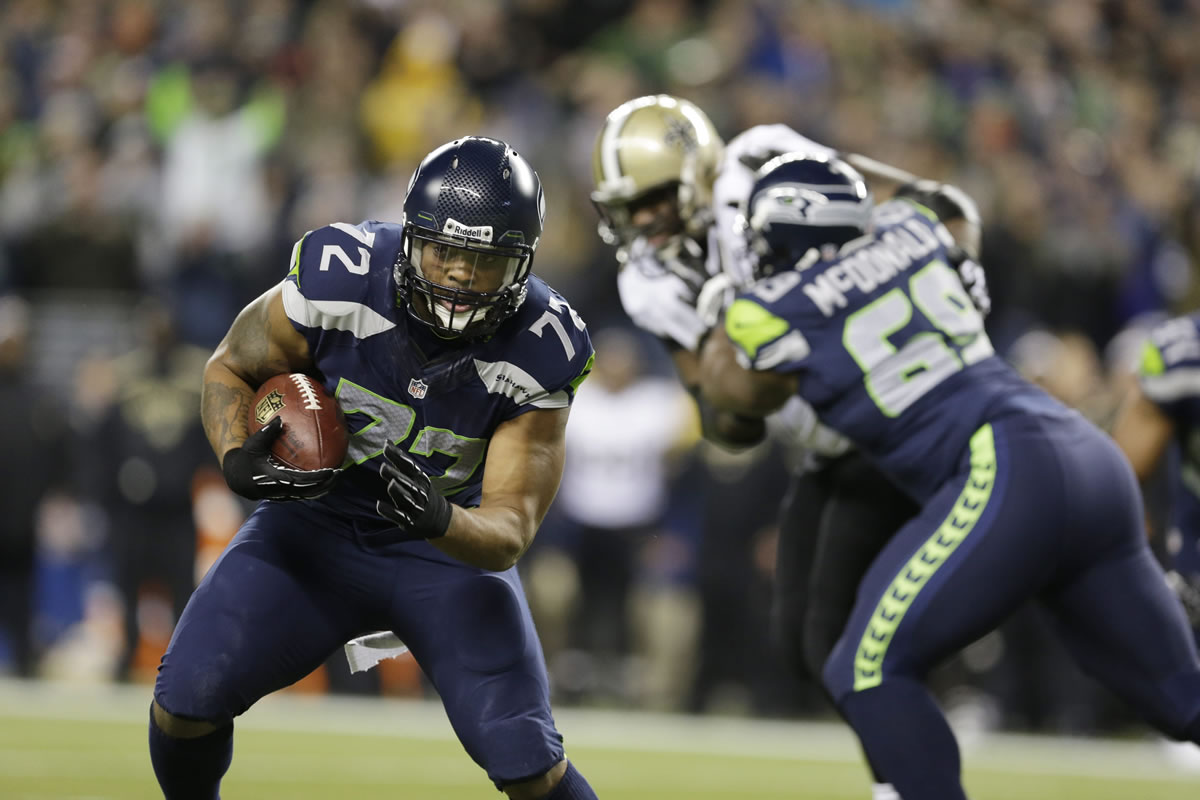 Seattle Seahawks' defensive end Michael Bennett returns a fumble for a touchdown against the New Orleans Saints in the first half of an NFL football game, Monday, Dec. 2, 2013, in Seattle.