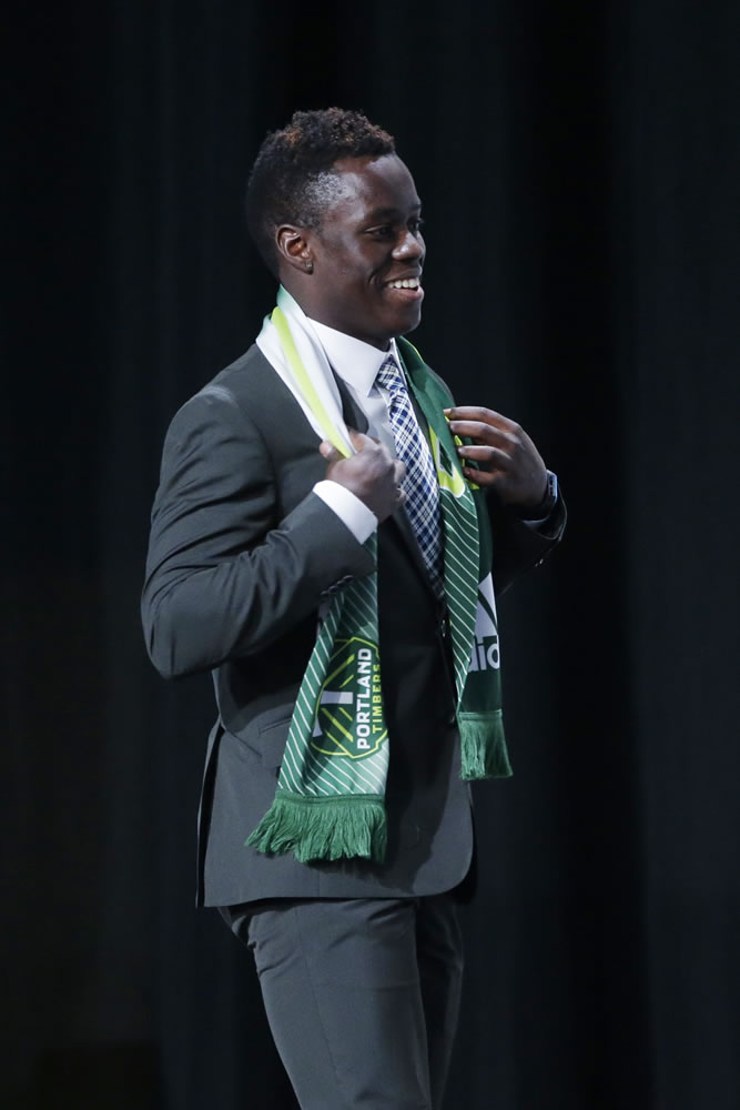 Schillo Tshuma walks on stage after being selected by Portland Timbers in the first round of the 2014 Major League Soccer SuperDraft, Thursday, Jan. 16, 2014, in Philadelphia.