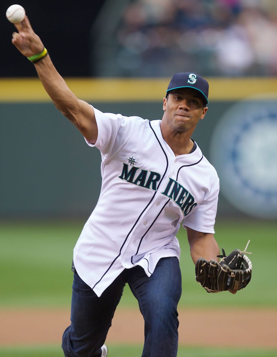 Seattle Seahawks quarterback Russell Wilson throws out the ceremonial first pitch before a Mariners game on June 7, 2013.