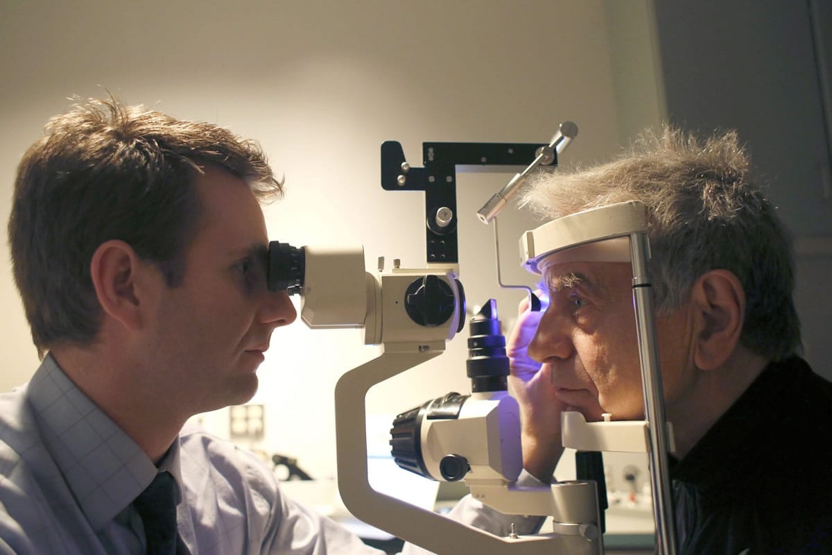 Dr. Isaac Porter does an eye examination on Neville Wood on Jan. 9 at his clinic in Raleigh, N.C.