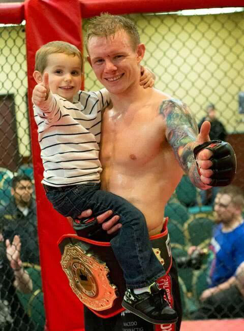 Austin Springer of Vancouver, holding son Jaxson, 3, after winning the first Main Event Sports Productions professional mixed martial arts championship on Saturday at the Red Lion Inn at the Quay.