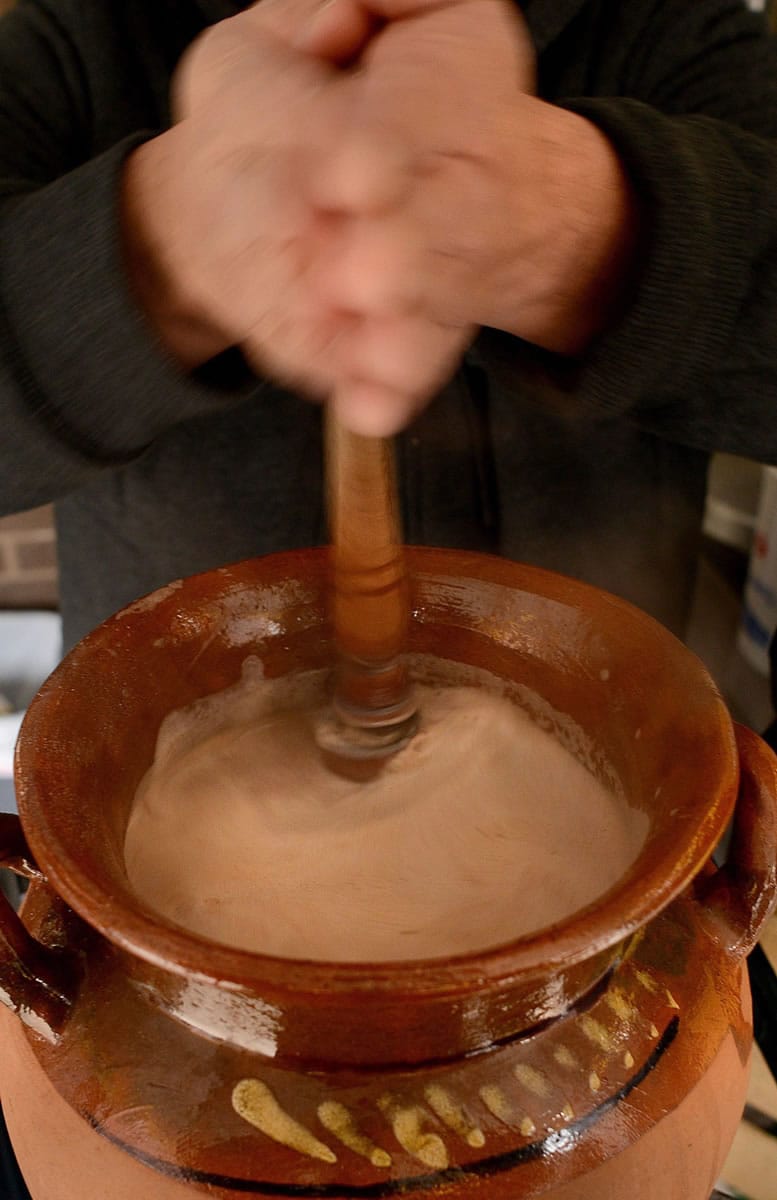 Thick hot chocolate is whipped by the molinillo as Edgar Alvarez prepares Mexican hot chocolate at his Pittsburgh stand in January.