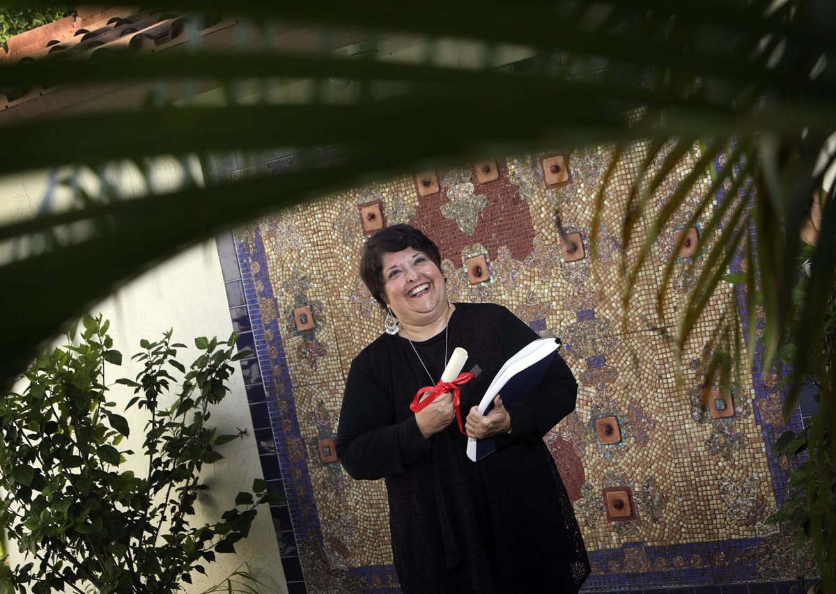 Genie Milgrom stands in the backyard of her Pinecrest home in front of a very special mosaic that she created. Milgrom, a Cuban woman who was raised Catholic, converted to Judaism after she began researching her maternal lineage.