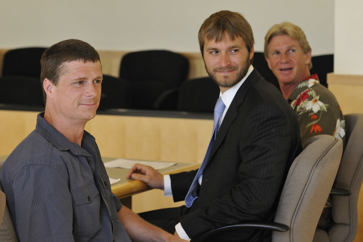 Alan Northrop, left, Innocence Project staff attorney John Pantazis and Larry Davis pose for a photograph July 14, 2010 before the beginning of a hearing set to officially dismiss  rape charges against the men on the basis of new DNA evidence.