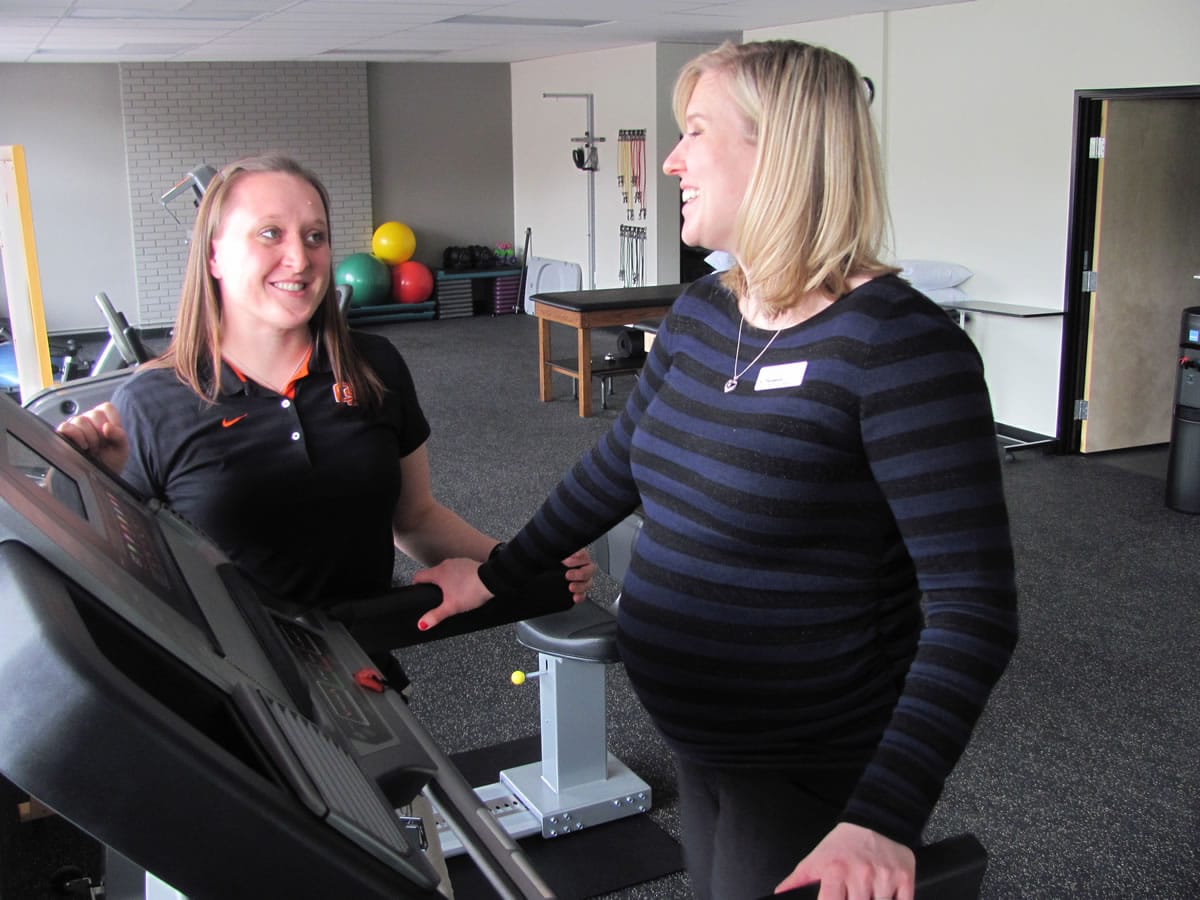 Clinic Director Lindsy Palisca observes Front Office Coordinator Jessica Groff walk on a treadmill at Therapeutic Associates Physical Therapy -- Camas. The new location provides athletic screens, orthopaedic and sports rehabilitation, performance training, physical fitness exams and work kinetics.