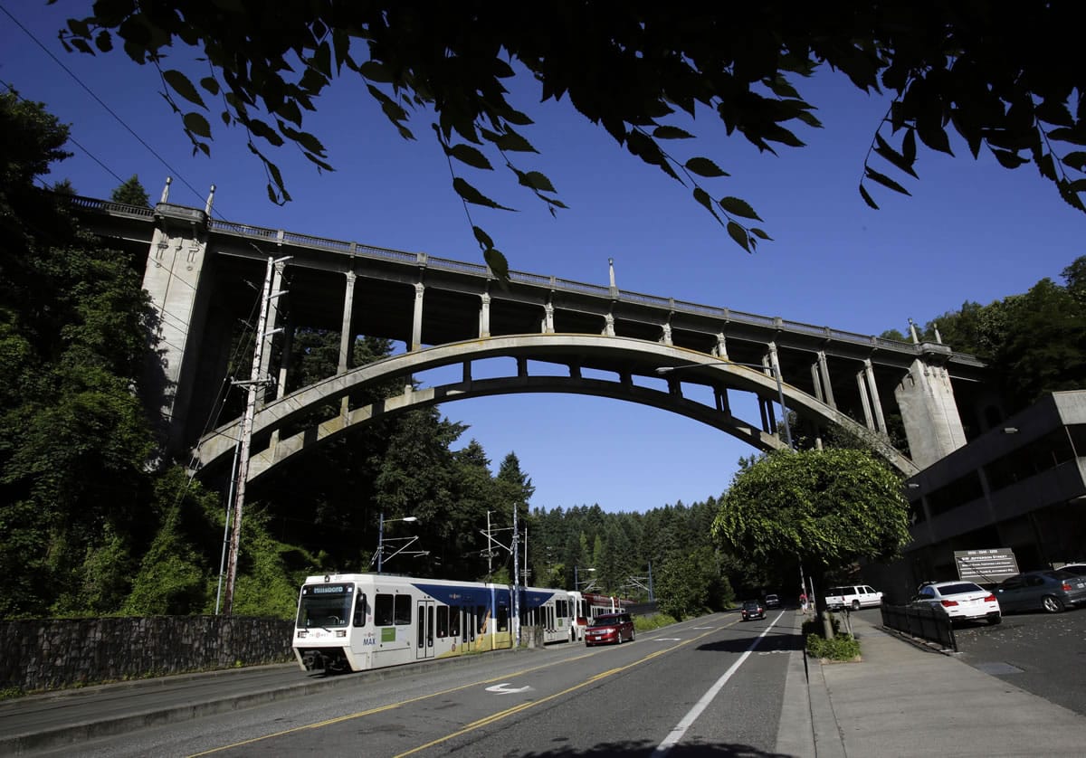 Light rail and traffic pass under the Vista Bridge, historically known as &quot;The Suicide Bridge&quot;, on  June 4 in the Goose Hollow neighborhood west of downtown Portland.