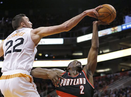 Portland Trail Blazers' Wesley Matthews has his shot blocked by Phoenix Suns' Miles Plumlee during the first half of the Blazers' season-opening loss in Phoenix.