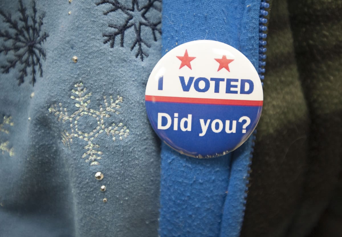 A voter wears an &quot;I Voted&quot; pin at Gaiser Hall, Clark College, on Tuesday in Vancouver.