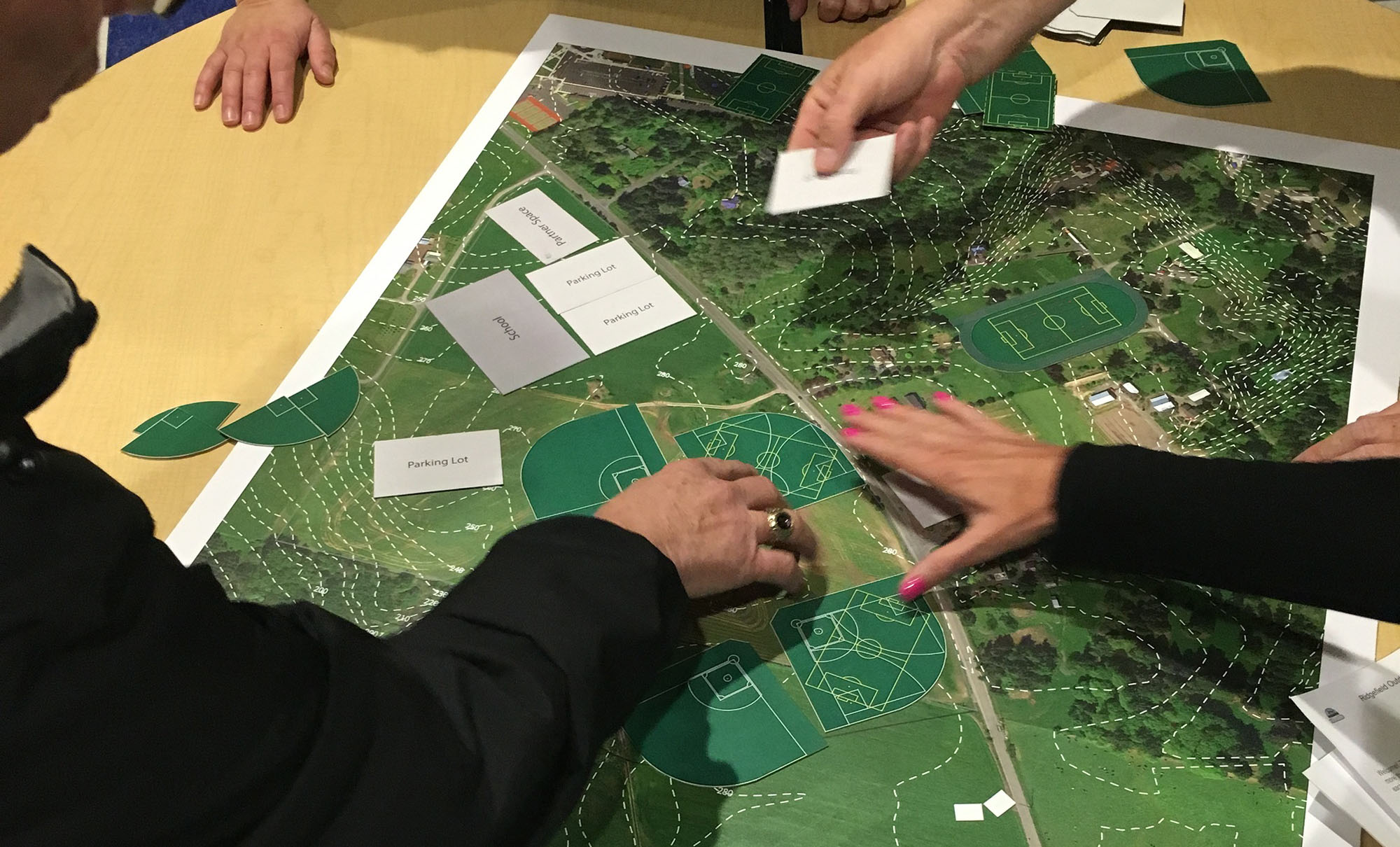 Ridgefield residents rearrange fields and buildings on an interactive map of a proposed outdoor recreation complex Thursday night.