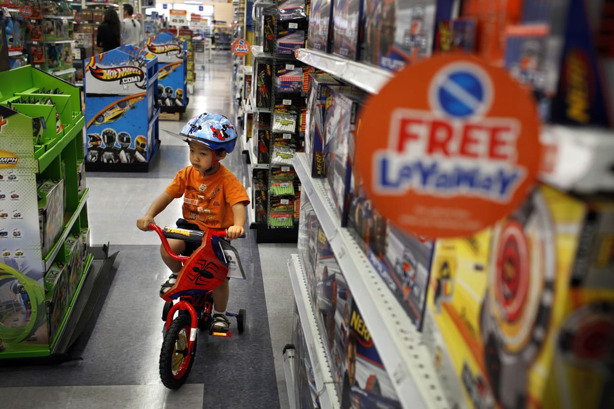 Nathan Pang, 3, test drives a bicycle around the Toys R Us store on Los Feliz Boulevard in Los Angeles.