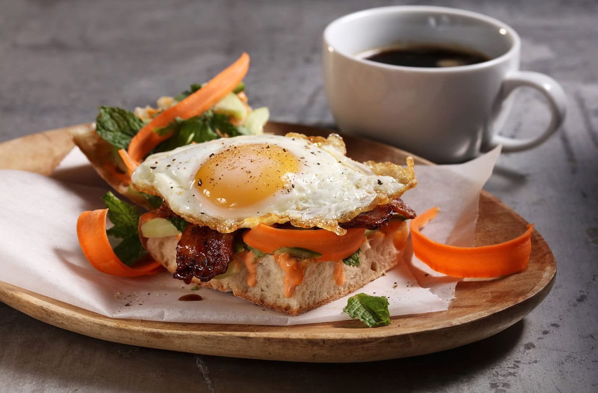 A banh mi breakfast sandwich adds egg and bacon to the traditional Vietnamese sandwich.