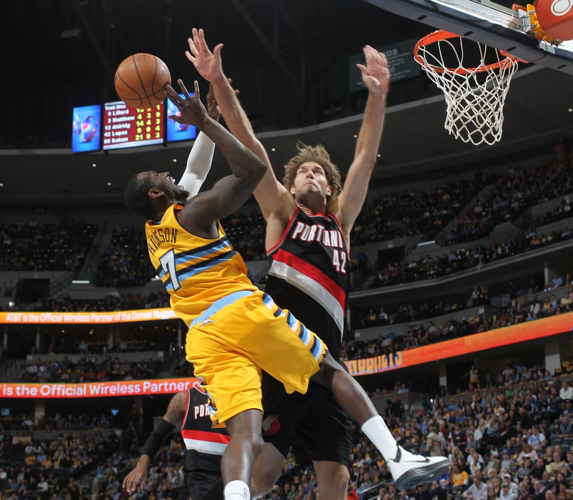 Denver Nuggets forward J.J. Hickson, left, has his shot blocked by Portland Trail Blazers center Robin Lopez in the third quarter of Portland's 113-98 victory in an NBA basketball game in Denver, Friday, Nov. 1, 2013.