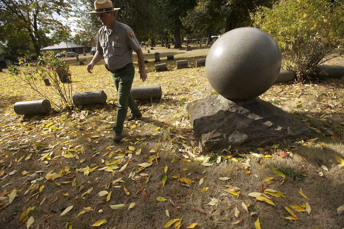 Fort Vancouver archaeologist Doug Wilson walks past grave markers in Vancouver's Old City Cemetery in 2012.
