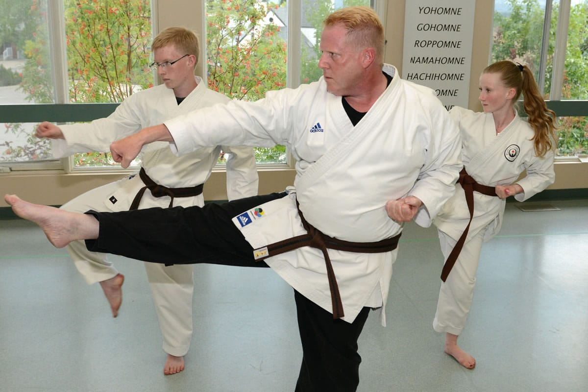 Craig Fallis, center, with his son, Bruce, 15, and daughter, Susanah, 12, walk through a Karate Kata at the Sentenashi Karate School in August in Calgary, Alberta, Canada.