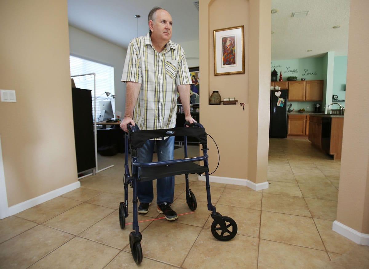 Wayne Puckett demonstrates his laser guided walker in Clermont, Florida. Puckett, 48, has a form of Parkinson's disease, which causes him to have great difficulty walking.