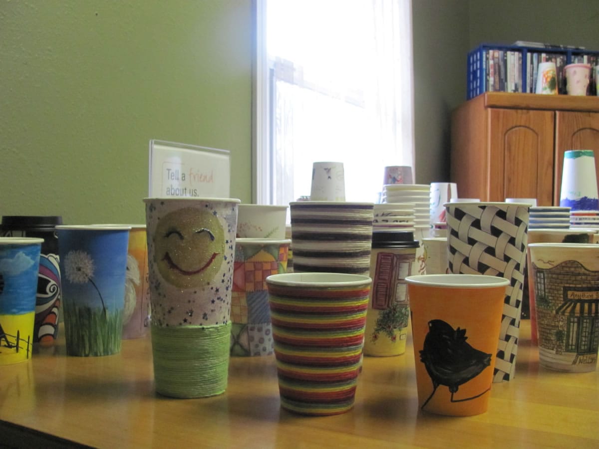 Michelle's Coffee Corner in Washougal is auctioning off decorated cups as a fundraiser for the arts program at Excelsior High School.