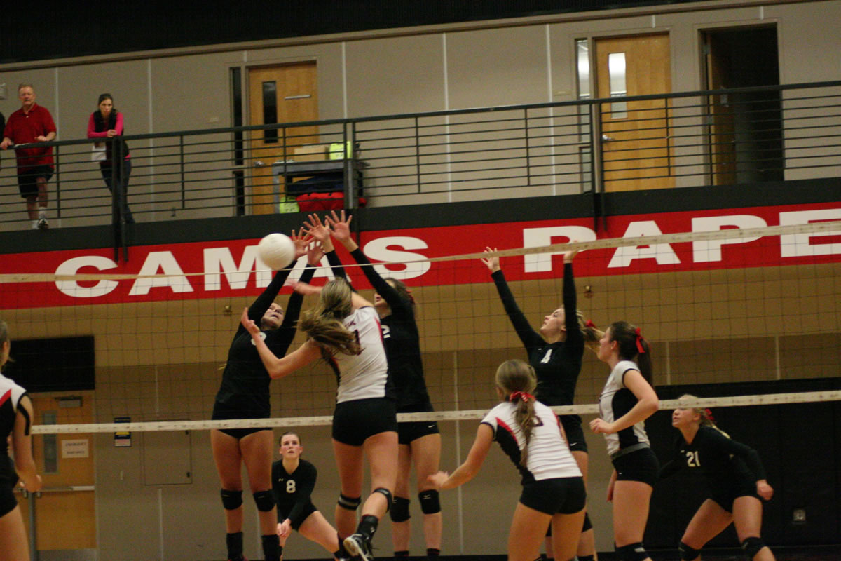 Lauren Harris and Sophi Jacobson  double up on the Union Titans at the volleyball net Wednesday, at   Camas High School.