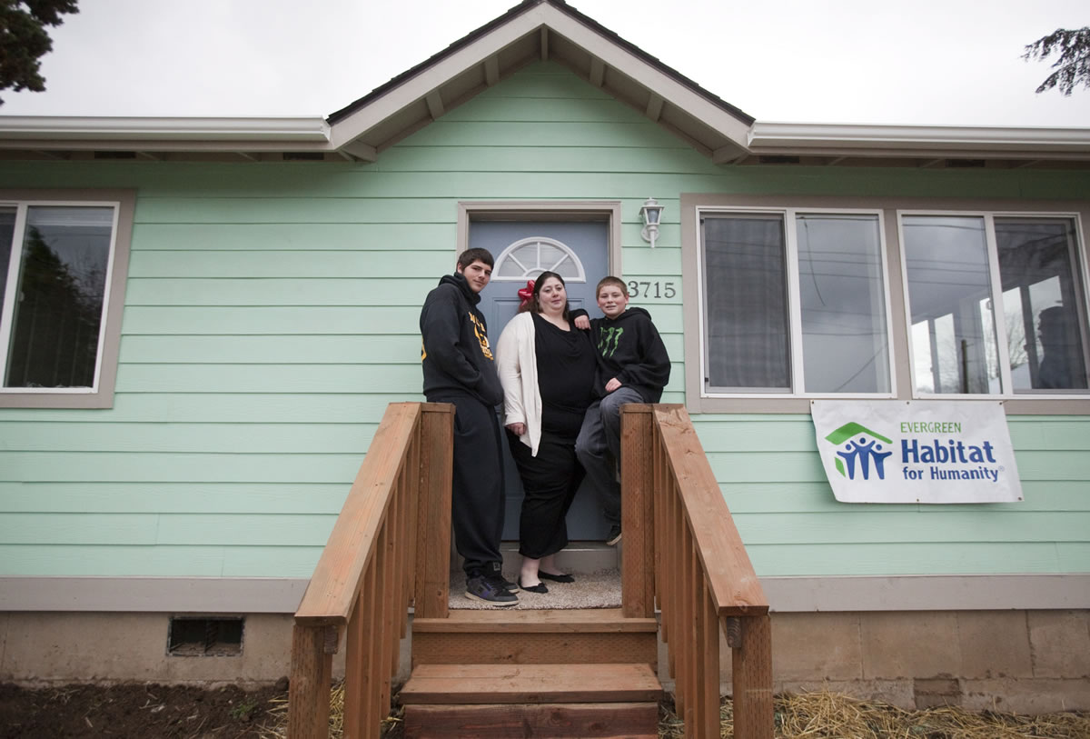 Nikki Danforth and her sons Coby, left, and Koda pose Sunday at their new home in the Lincoln neighborhood.