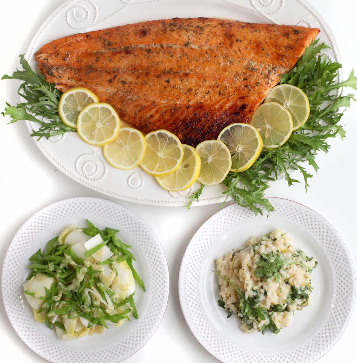 Maple glazed salmon serves as the centerpiece of this meal with leeks and kale risotto.