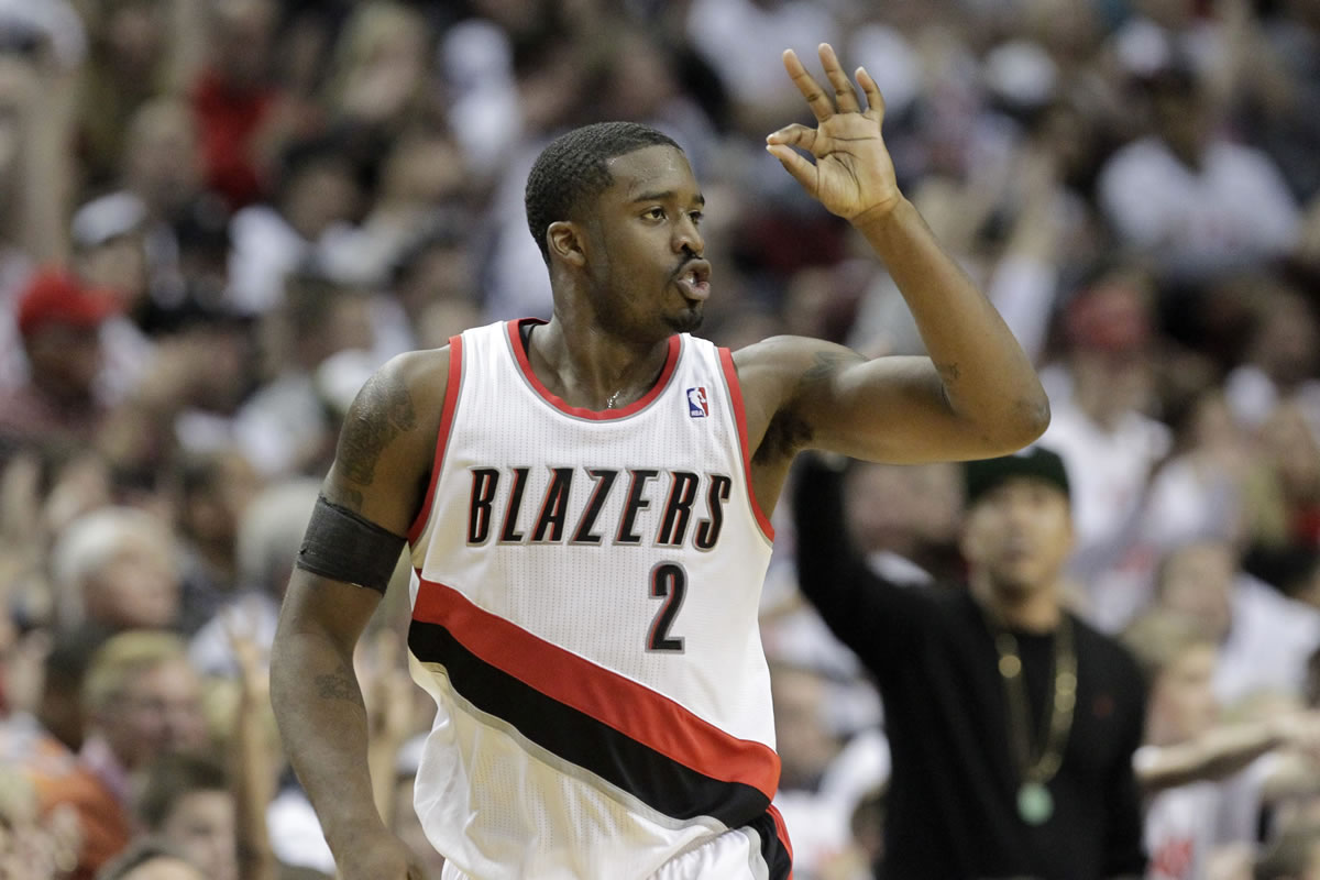 Portland Trail Blazers guard Wesley Matthews holds up three fingers after sinking a three point basket during an NBA basketball game against the San Antonio Spurs in Portland, Ore., Saturday, Nov. 2, 2013.