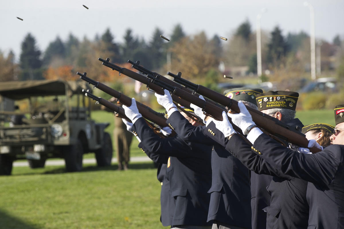Shell casings fly as a Veterans of Foreign Wars detail fires a rifle salute during Monday's Veterans Day Celebration at the Armed Forces Reserve Center in east Vancouver.