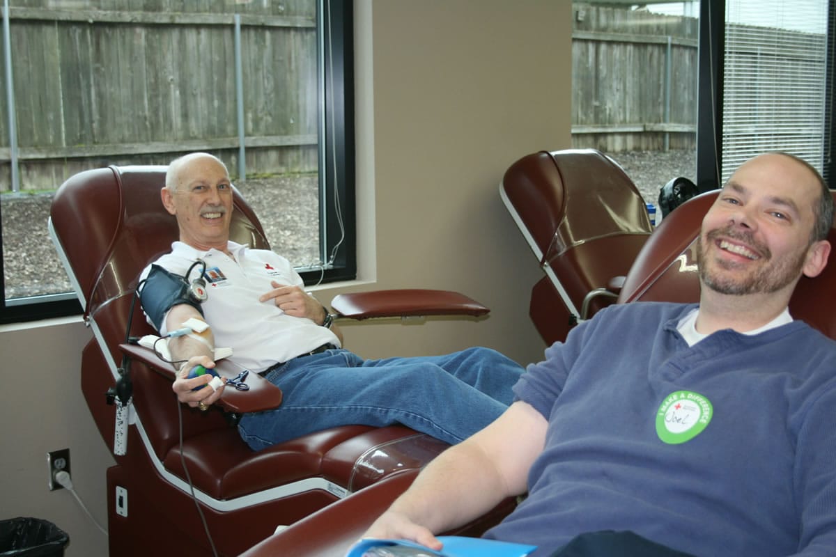 Jim Boline, left, and his son Joel donated blood at the same time at the American Red Cross Donor Center, near Vancouver Mall.