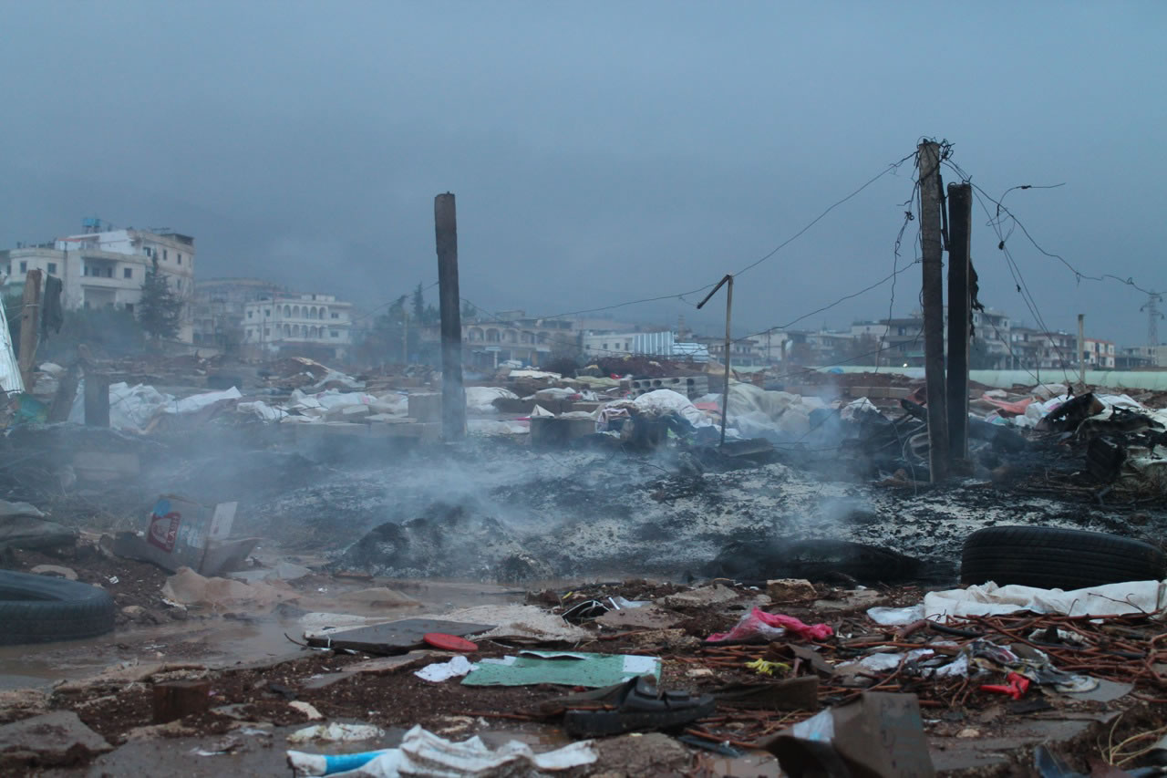 The smoldering remains of a Syrian refugee camp in Qasr Naba, Lebanon, are shown on Dec. 3.
