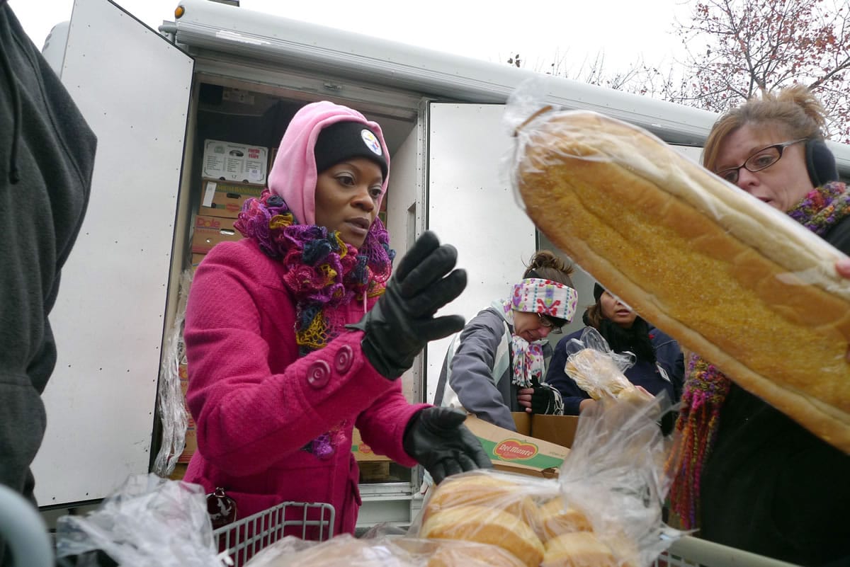 Quinetta Rascoe, left, helps distribute food to needy families Nov. 12 in the parking lot of a local church in Murfreesboro, N.C.