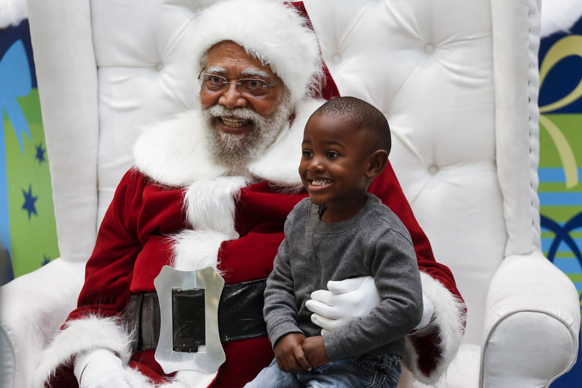 Jahleel Logan, 3, poses with Santa, a.k.a. Langston Patterson, 77, at the Baldwin Hills Crenshaw Plaza in Los Angeles on Dec. 7.
