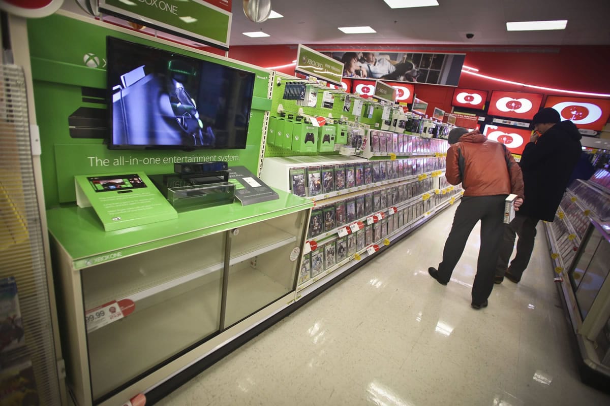 Customers look at Xbox games despite the fact that all the Xbox Ones were sold out at Target in downtown Minneapolis.