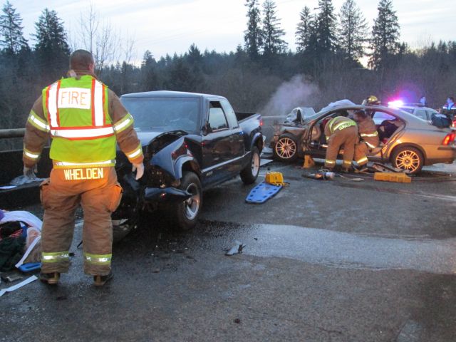 Rescue crews respond Thursday afternoon to a two-vehicle collision near milepost 85 on Highway 30, about 10 miles east of Astoria, Ore.