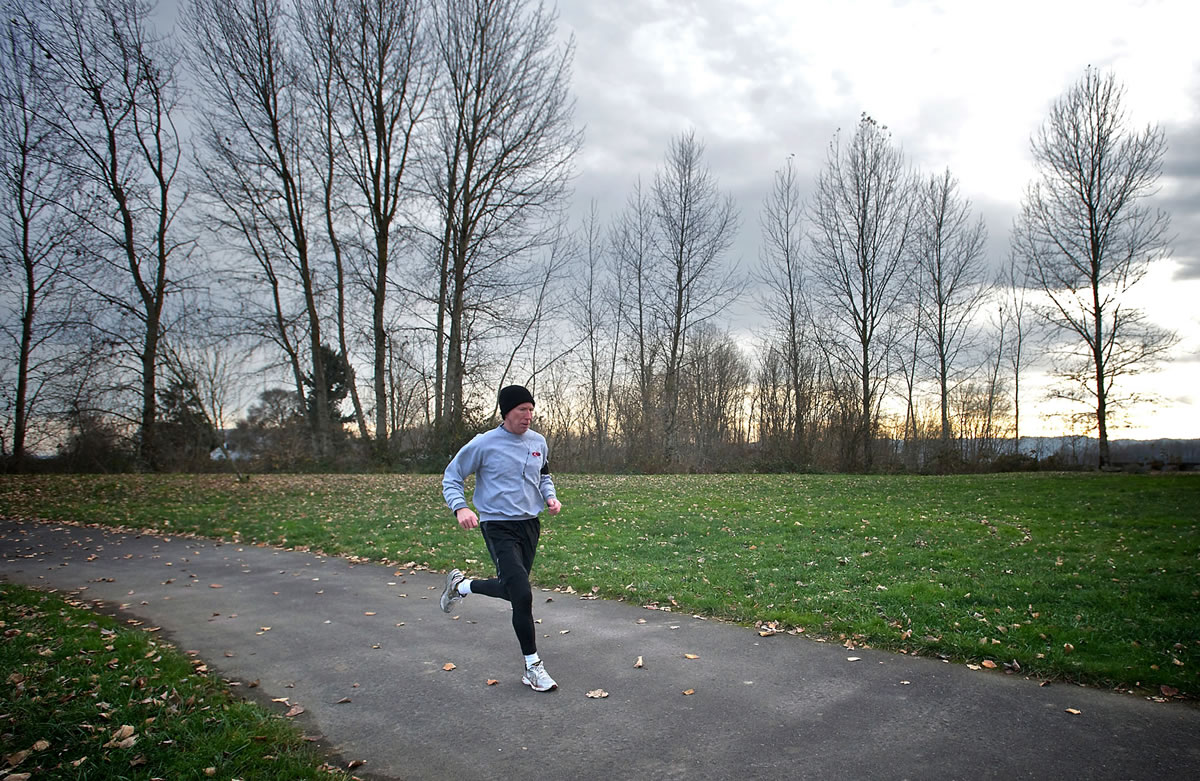 A man runs Thursday along the waterfront where the Waterfront Renaissance Trail and Frenchman's Bar Trail meet in Vancouver.