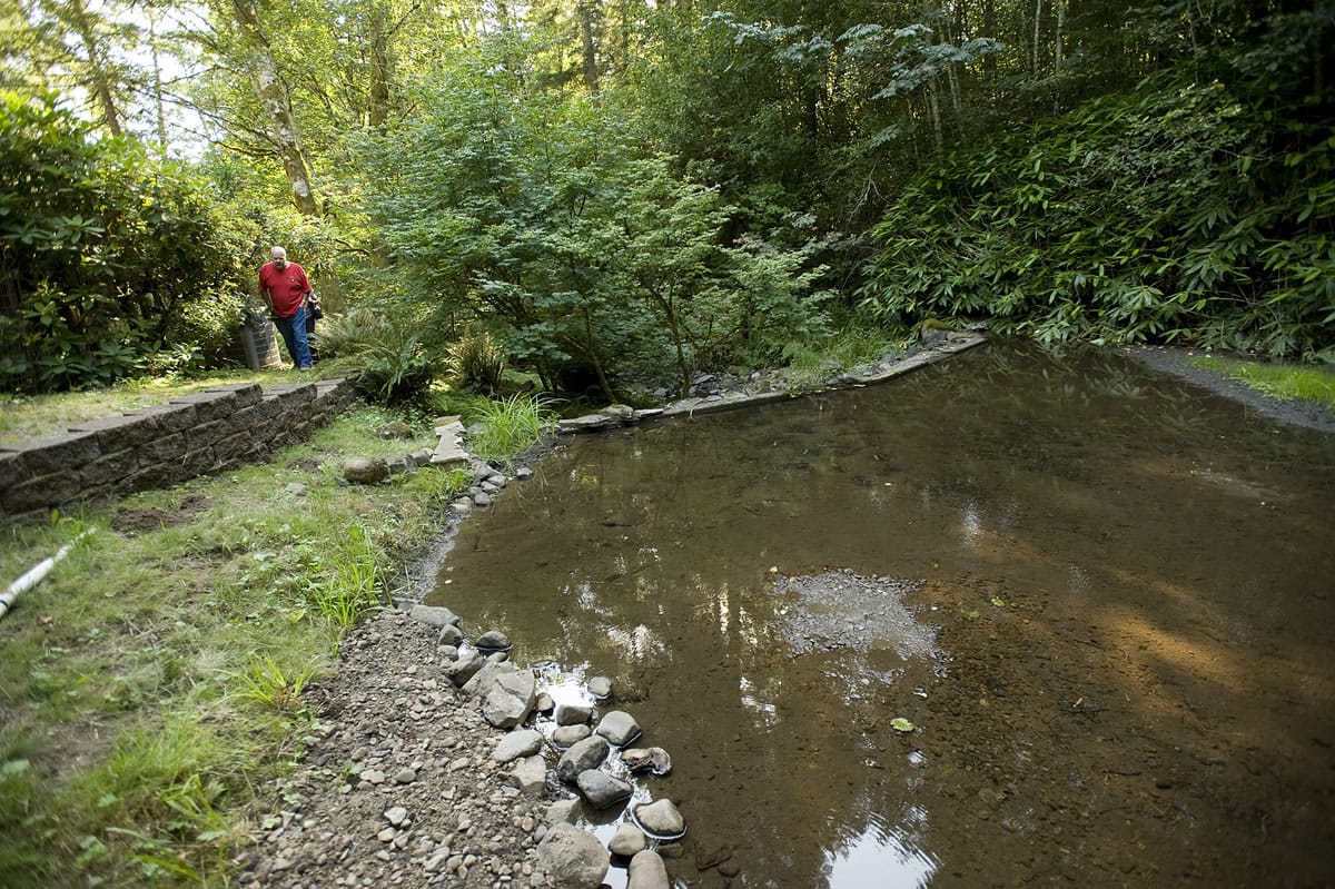 David Rogers shows a neighbors pond that had silted in after blasting started at the Yacolt Mountain Quarry in 2011.