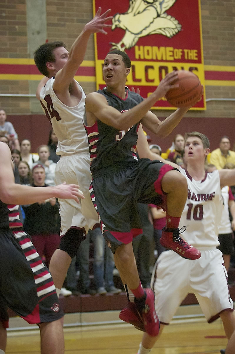 Jordan Suell (35) of Fort Vancouver High School drives to the basket against defender Ronnie McPherson (44) of Prairie High School on Tuesday.