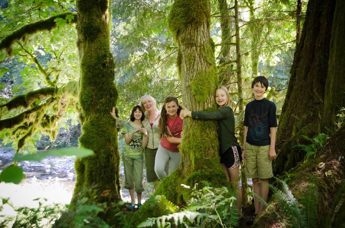 Michelle Baumann, second from left, founder of TreeSong Nature Awareness and Retreat Center, teaches children to appreciate the outdoors during a summer camp earlier this year at the newly opened Washougal center.