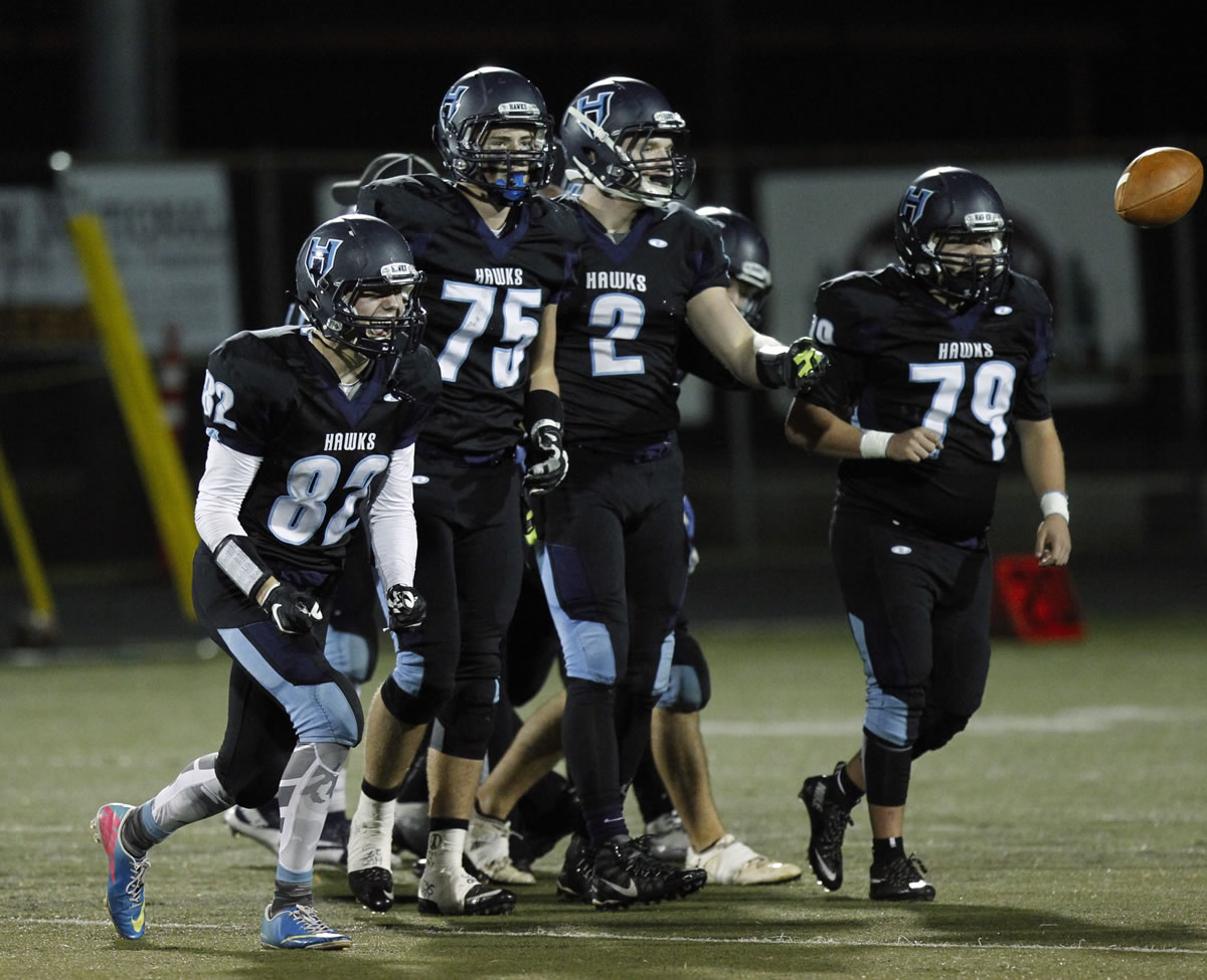 Hockinson defenders (left-right) Nick Martin, Zachary Saeman, Cameron Loos and Harry Fosteer celebrate a fumble recovery against Liberty in the first round of the state playoffs.