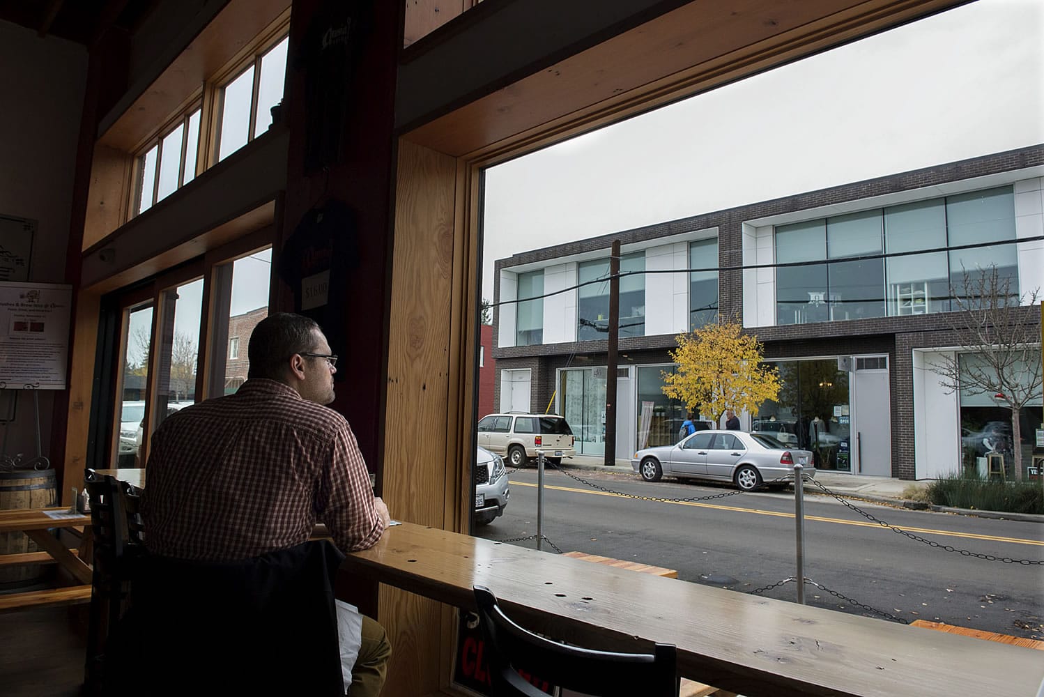 Jeremy Chitwood of Salem, Ore., checks out the view from Amnesia Brewing while enjoying lunch Thursday afternoon in up-and-coming downtown Washougal. A new downtown association is trying to build on the recent success Washougal has had in attracting new businesses and customers.