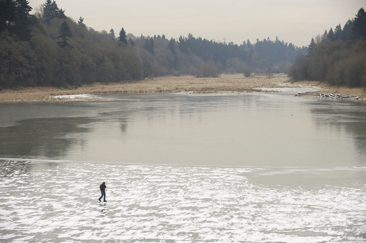 Stephen Stewart explores the icy conditions around Burnt Bridge Creek on Monday in Vancouver. &quot;I'm calling my friends to tell them I'm walking on water,&quot; Stewart said.