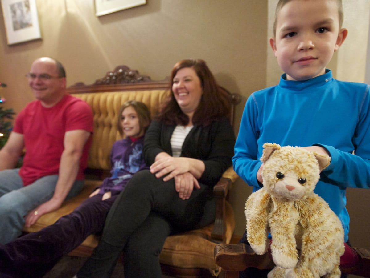 Six-year-old Cole Merle shows off his stuffed cat named Scratchy that he received when checking into Doernbecher Children's Hospital in Portland for chemotherapy treatment.