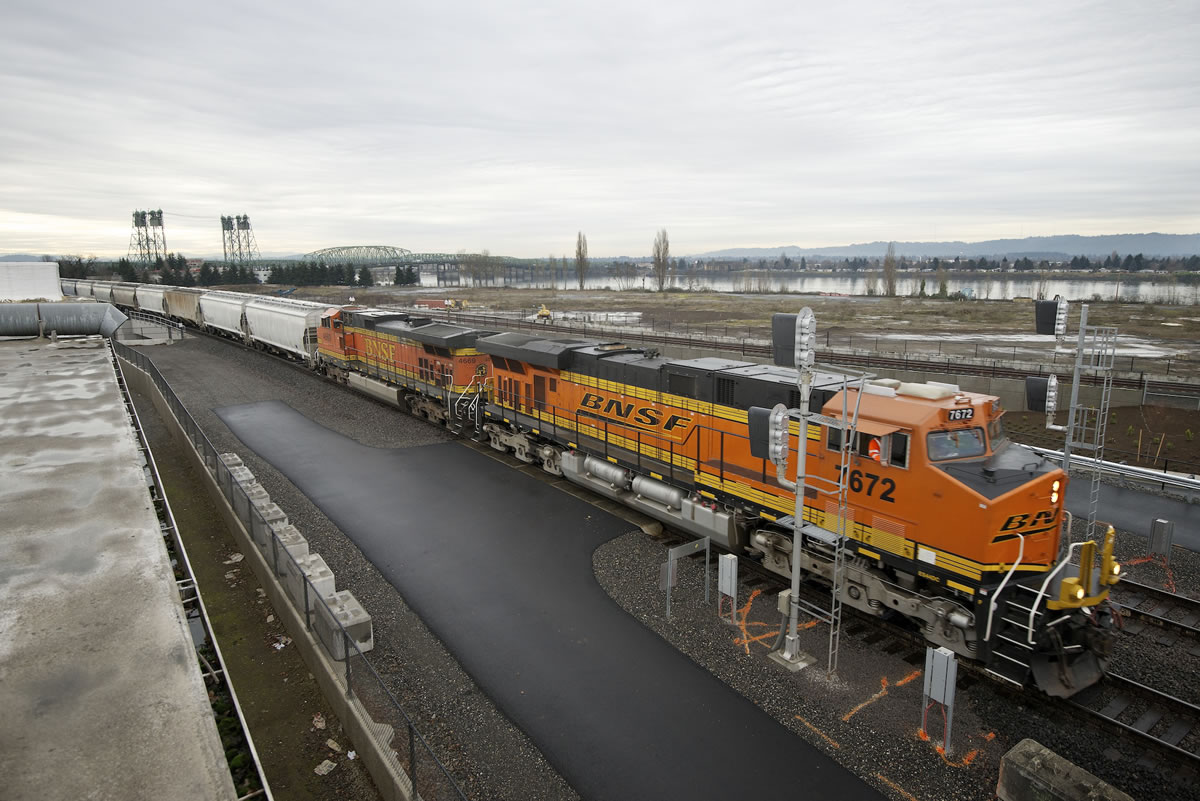 A BNSF Railway train moves grain along tracks adjacent to the city of Vancouver's waterfront site.
